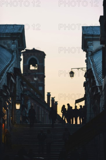 Tourists as silhouette on the Rialto Bridge in the last evening sun, crowded, full, city trip,