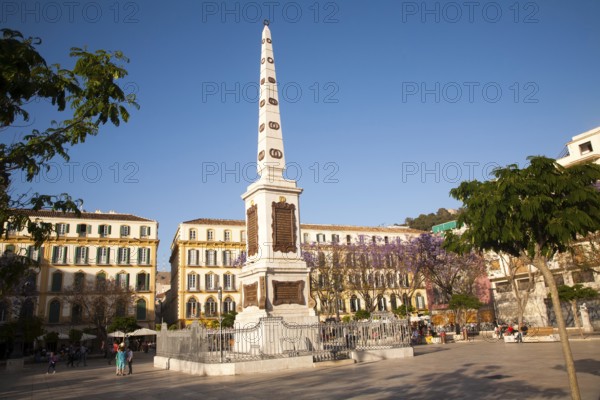 People enjoying a sunny spring afternoon in Plaza de la Merced, Malaga Spain