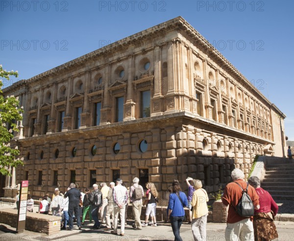 Tour group of tourists outside the Palacio de Carlos V, Palace of King Charles the Fifth, the