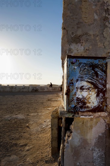 Fortress wall with picture of Jimi Hendrix, evening mood in the harbour town of Essaouira, Morocco,