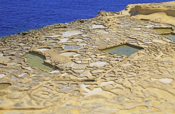 Historic ancient salt pans on coast near Marsalforn, island of Gozo, Malta, Europe