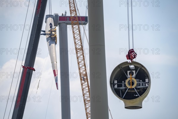 Erection of an Enercon E-160 wind turbine, rear, assembly of the first blade, 4 turbines with a