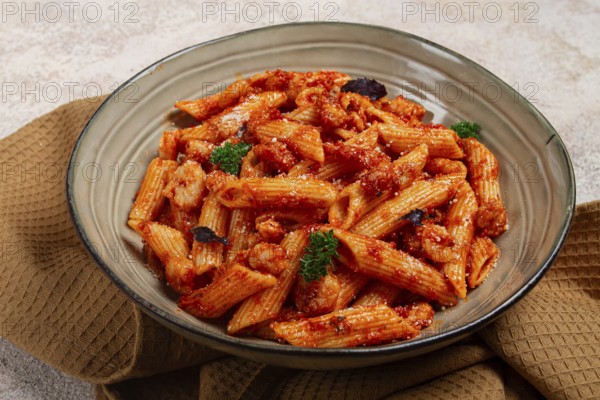 Penne pasta, with shrimp in tomato sauce, close-up, no people