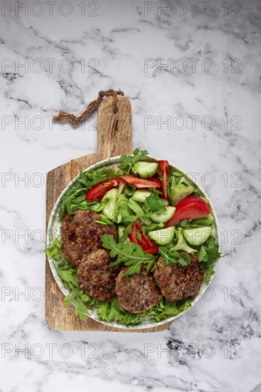 Fried cutlets, mixed minced meat, with vegetable salad, homemade, top view, no people