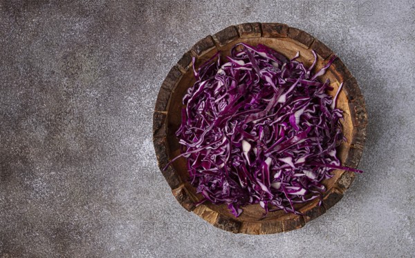 Red cabbage, sliced, in a wooden salad bowl, top view, no people