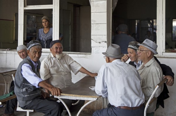 Kyrgyz elderly men wearing traditional tubeteikas in Osh, Kyrgyzstan, Asia