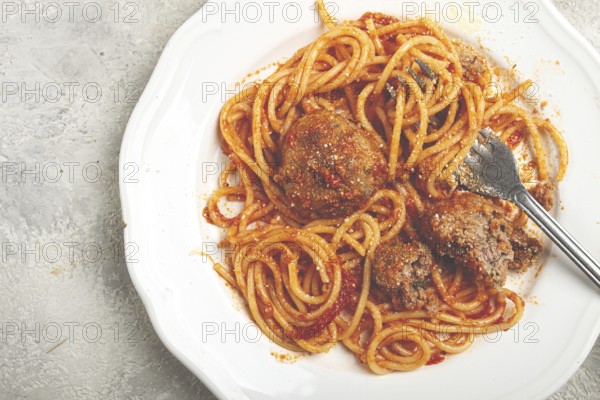 Spaghetti with meatballs in tomato sauce, on a white plate, no people, homemade