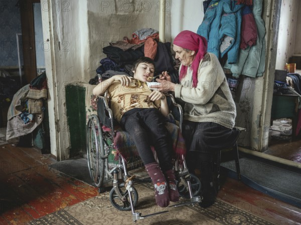 Lena, 70 years old, cares for her severely disabled granddaughter Lena, 18 years old. The family