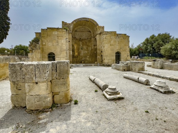 View of ancient ruins of Titus Basilica, in the foreground remains of stones foundation walls of