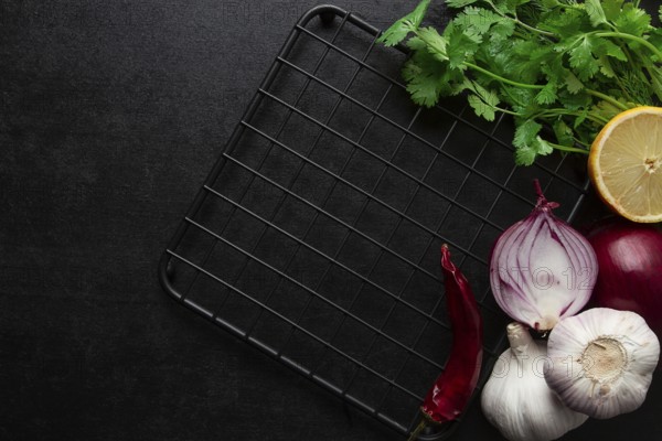 Food concept, black table, hot plate, spices, top view, no people horizontal