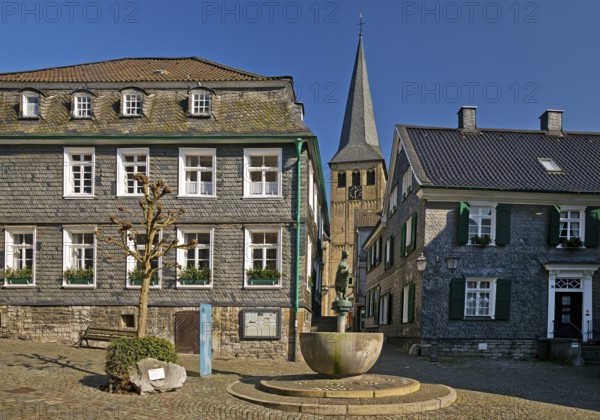 Historic upper town with horse fountain and church tower of St. Lambertus, Mettmann, Bergisches