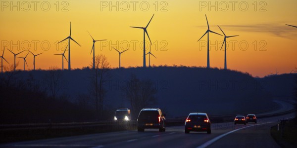 Wind turbines at sunrise with cars on the A 44 motorway, Büren, Paderborn plateau, North