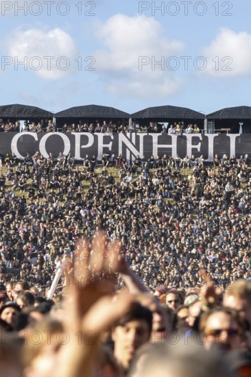 Copenhagen, Denmark - 19 June 2024: Festivalgoers in front of the logo at the Copenhell Metal