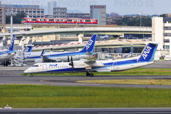 An ANA Wings Dash 8 Q400 aircraft with registration number JA842A at Itami Airport (ITM) in Osaka,