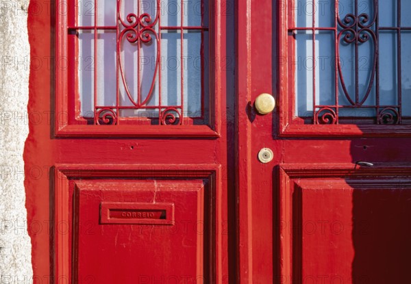 Close-up of vividly red doors on the historical façade in the Ribeira district, Porto, Portugal,