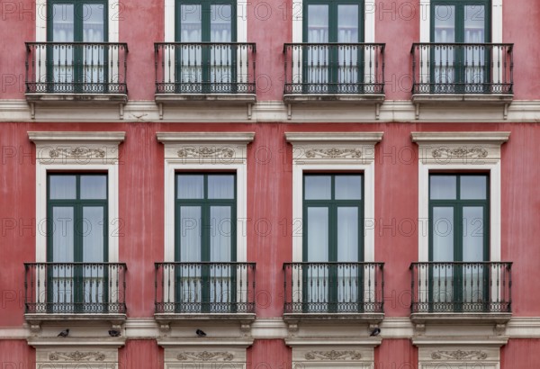 House façade with floor-to-ceiling windows and French balconies, Malaga, Andalusia, Spain, Europe