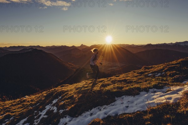 Trail running in autumn on the Jochberg on Lake Walchensee against the wonderful backdrop of the