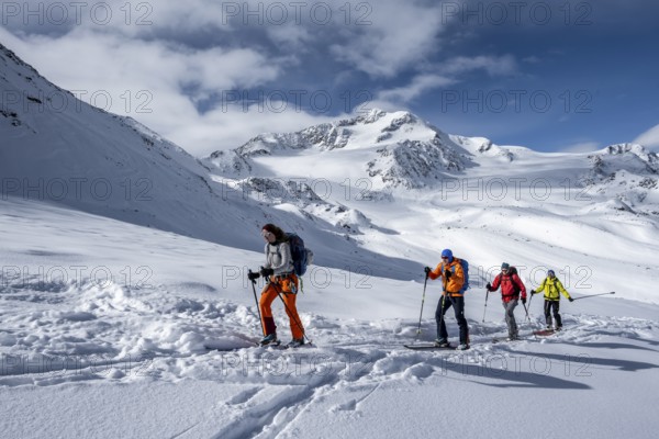 Ski tourers, behind the summit of Monte Cevedale, snow-covered mountain landscape, Ortler Alps,