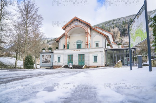 Wide angle shot of a historic theatre in the snow, surrounded by wintry nature, Königliches