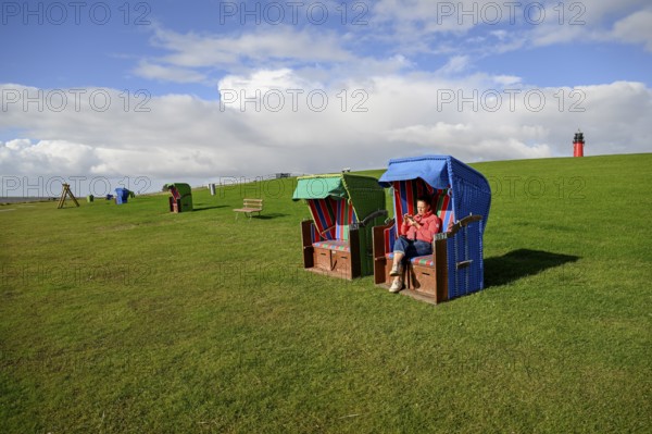Woman in a beach chair on the island of Pellworm, Wadden Sea National Park, North Frisia, Germany,