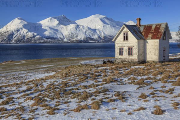 Old house, dilapidated, fjord, mountains, sunny, winter, Lyngen Alps, Norway, Europe