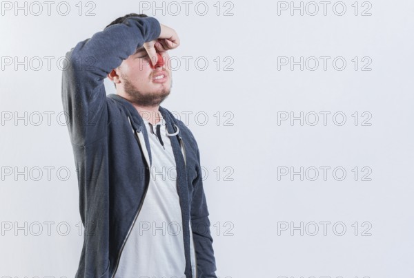 Suffering man with nasal bridge pain isolated. Guy suffering with nasal bridge on isolated
