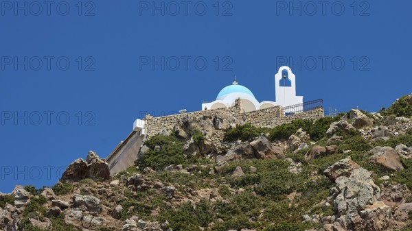 White-blue church on a rock under a clear blue sky, Church of Profitis Ilias, above Nikia, Nikia,