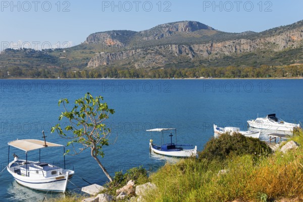Sea view with several boats, surrounded by mountains in clear, sunny weather, Agia Kyriaki,