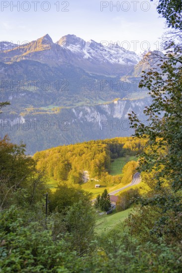 Panoramic view of alpine landscape with autumn forest and road in the valley, Lauterbrunnen,