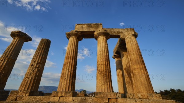 Archaic Temple of Apollo, Doric columns of a temple rise proudly under a bright blue sky,