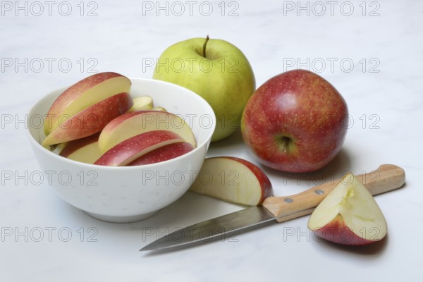Apple and apple slices in peel, sliced apple with knife