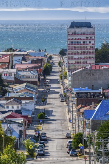 View from a hill over streets and houses to the Strait of Magellan, city of Punta Arenas,