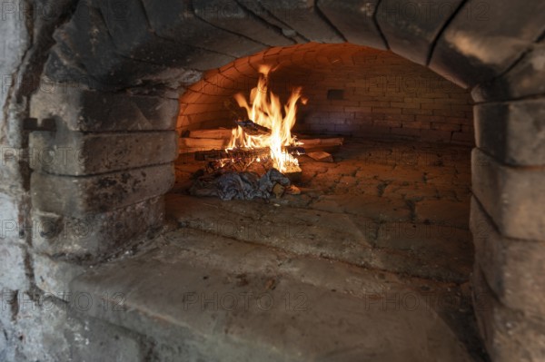 Wood fire in a baking oven in preparation for baking bread, baking oven festival in Franconia