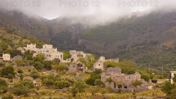 Village in the mist surrounded by mountains and greenery, Mani Peninsula, Peloponnese, Greece,