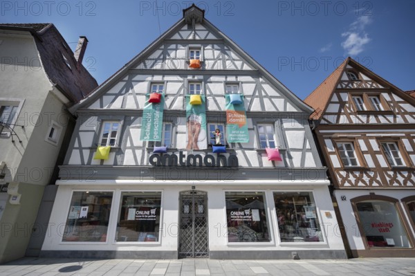 Historic half-timbered house with mattress advertising on the façade, Forchheim, Upper Franconia,