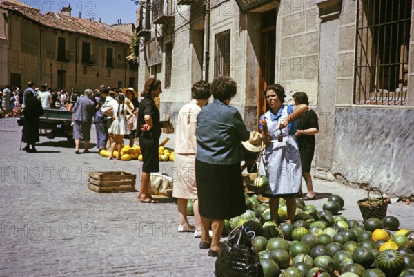 Selling watermelons and honeydew melons at the street market, Segovia, Castilla y León, Spain 1964