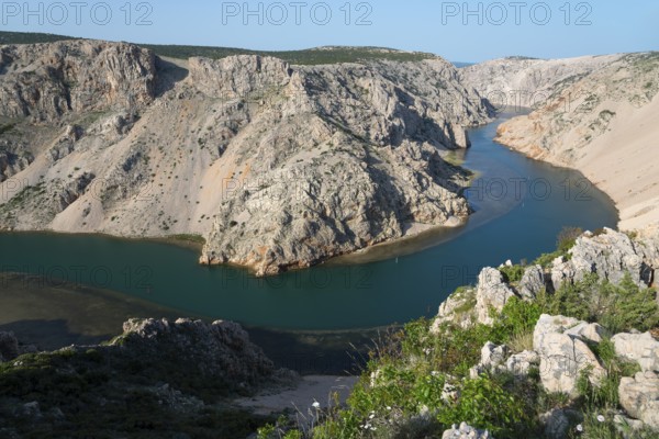 River winds through rocky canyon surrounded by lush green vegetation, Pariževacka Glavica,