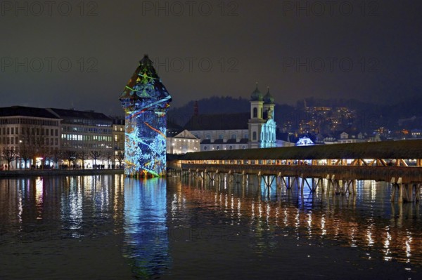 Wassertum with light installation, Chapel Bridge on the right, Jesuit Church on the Reuss at dusk