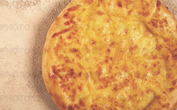 Khachapuri in Megrelian, a traditional Georgian dish, flatbread with cheese, top view, no people