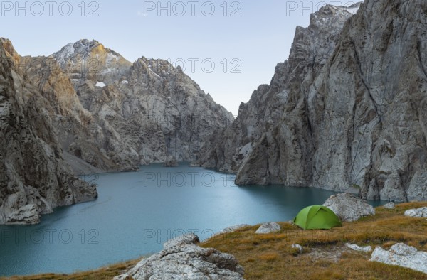 Wild camping, camping in the wilderness with a tent in front of mountain lake Kol Suu, Sary Beles