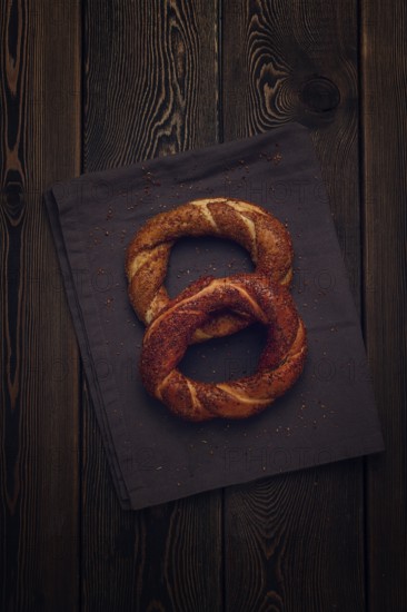 Traditional Turkish bagel Simit, Top view on a wooden table, vertical, no people, rustic style