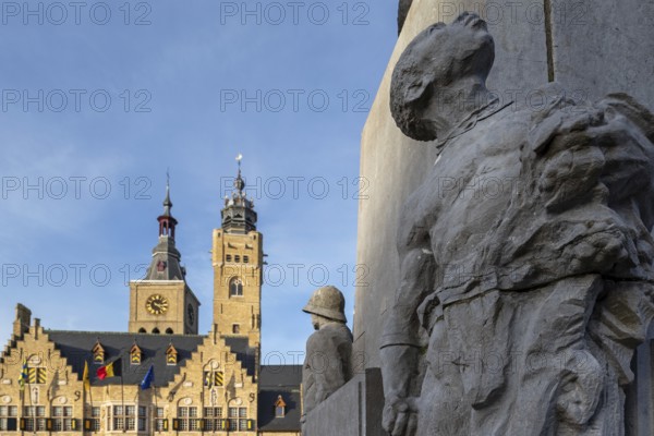 Detail of statue Jacques de Dixmude showing African slave on Market square with town hall and belfy