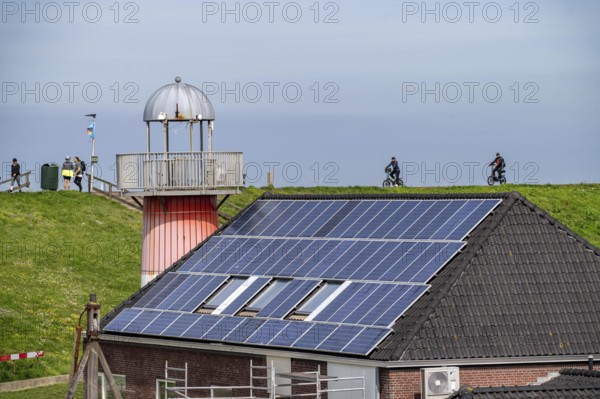 Solar modules on roofs, on the roof of a building on the dyke, North Sea coast, in Zeeland,