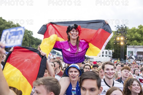Celinda celebrates with a German flag on her boyfriend's shoulders in the fan zone at the