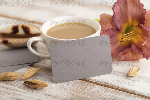 Gray paper business card mockup with purple day-lily flower and cup of coffee on white wooden
