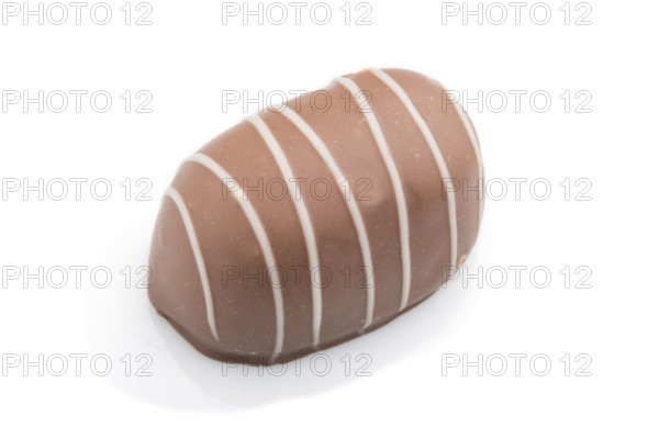 Single chocolate candy isolated on white background. side view, close up