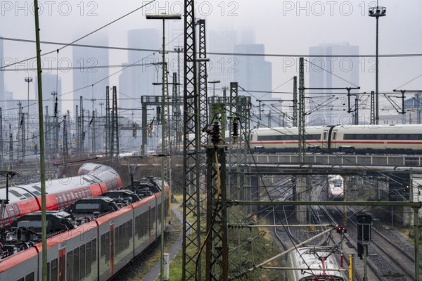 Railway tracks with regional and long-distance trains, ICE, after freezing rain, in front of