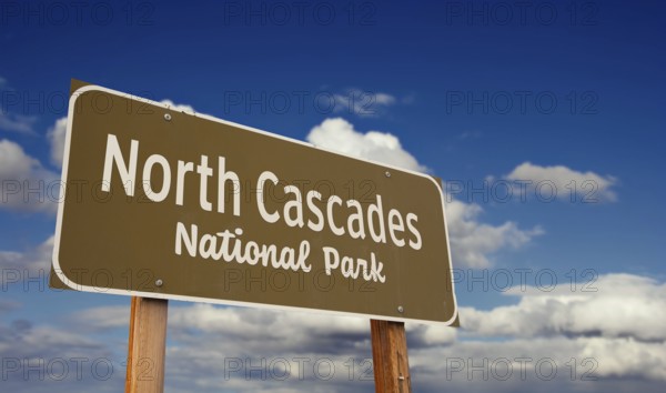 North cascades national park (washington) road sign against blue sky and clouds