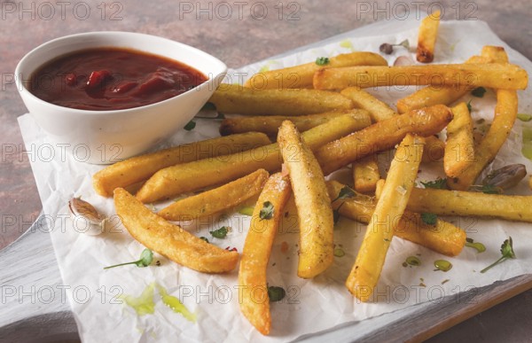 Fried French fries, in a paper bag, on an abstract background, no people, rustic