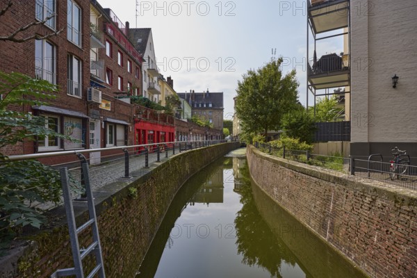 Residential and commercial building on the Nördliche Düssel river in the historic city centre of